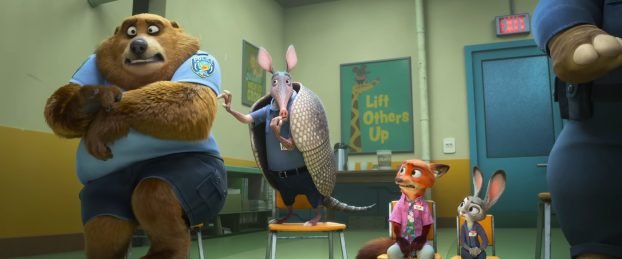 Nick and Judy sit in chairs next to armadillo who is picking a bear's hair. They are in buddy counseling.