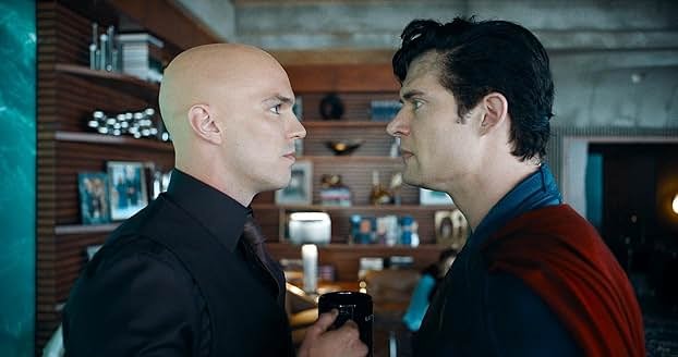 Lex faces Superman, with each looking into each other's eyes in a standoff.