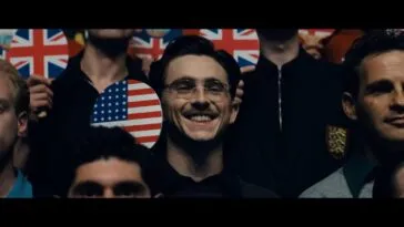 Marty holds the U.S. Ping Pong Paddle and smiles for a group picture.