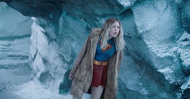 Supergirl ducking through a section of Superman's Fortress of Solitude.